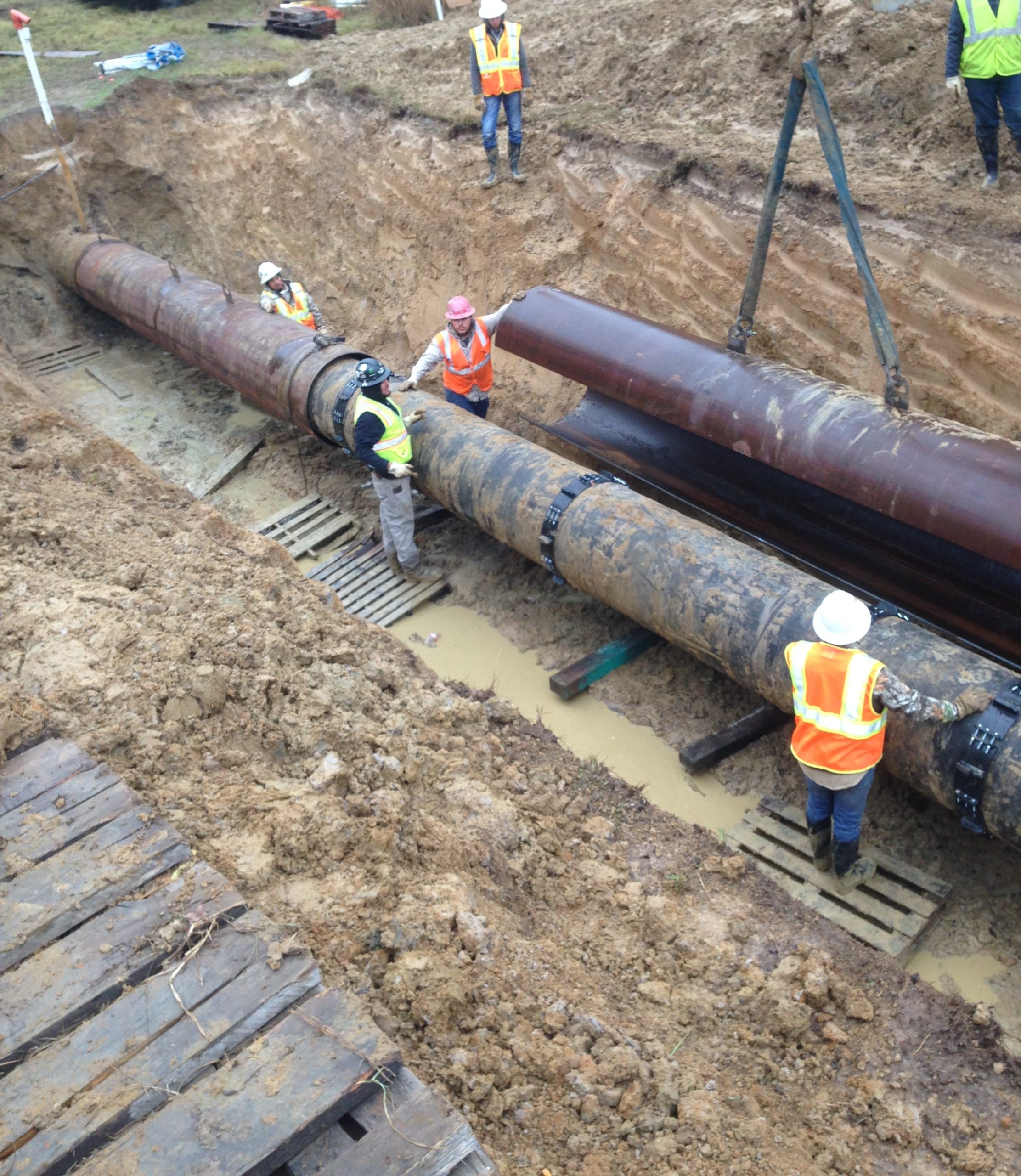 men working on pipeline encroachment job site